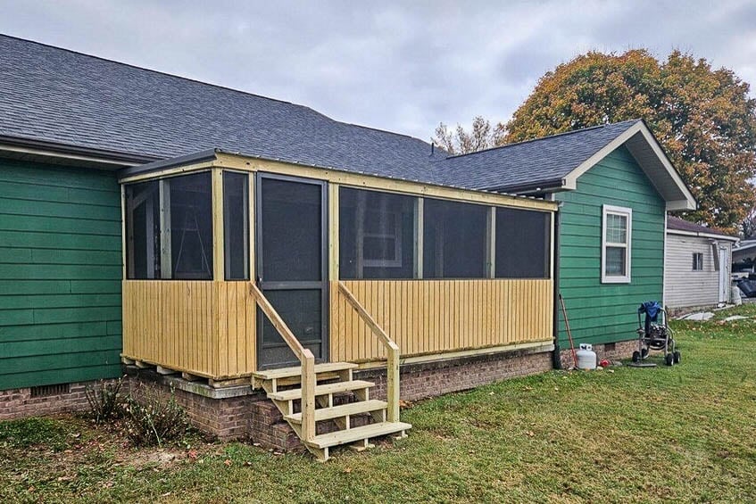 8x20 screened porch with wood framing and steps attached to a green house in Rickman, Tennessee.