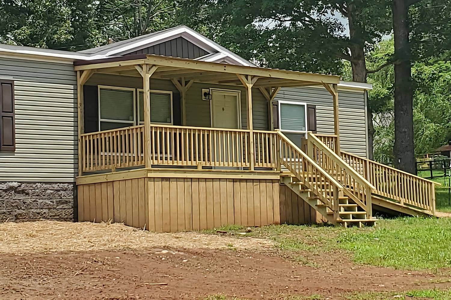 View of porch in Tennessee with wooden undersiding, stairs, ramp, and roof