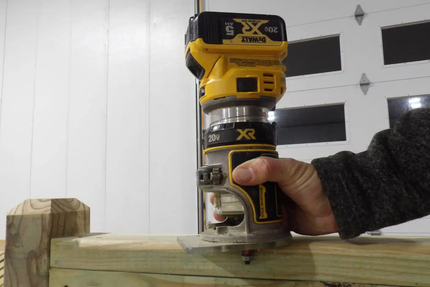 man using router on wood edges