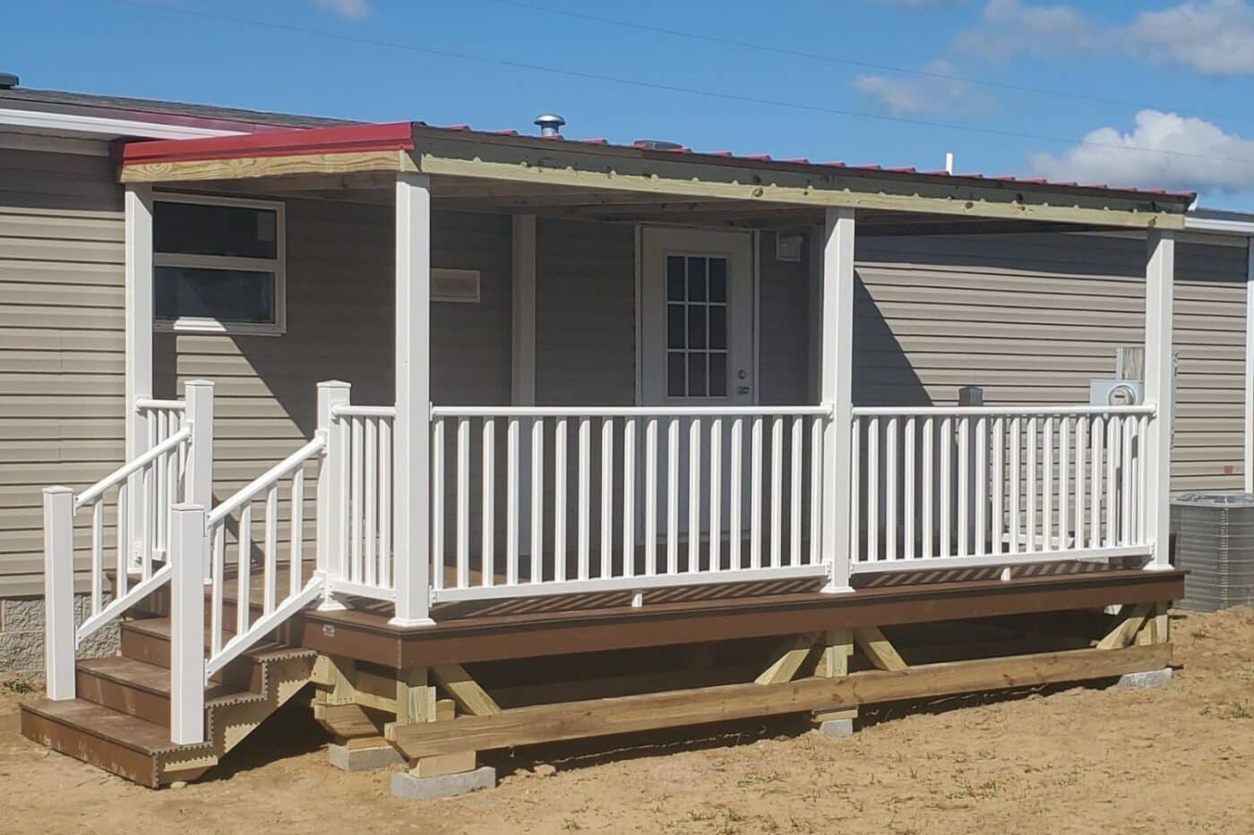 View of foundation under mobile home porch in Tennessee. Wooden structure sits on top of concrete blocks