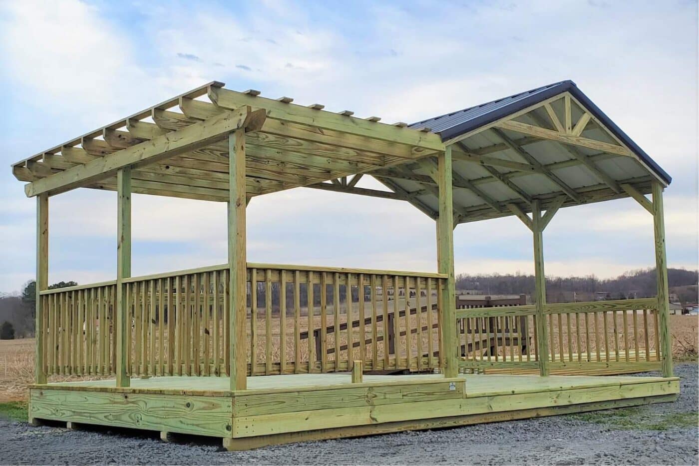 Pavilion with attached pergola on gravel lot in front of field in Kentucky