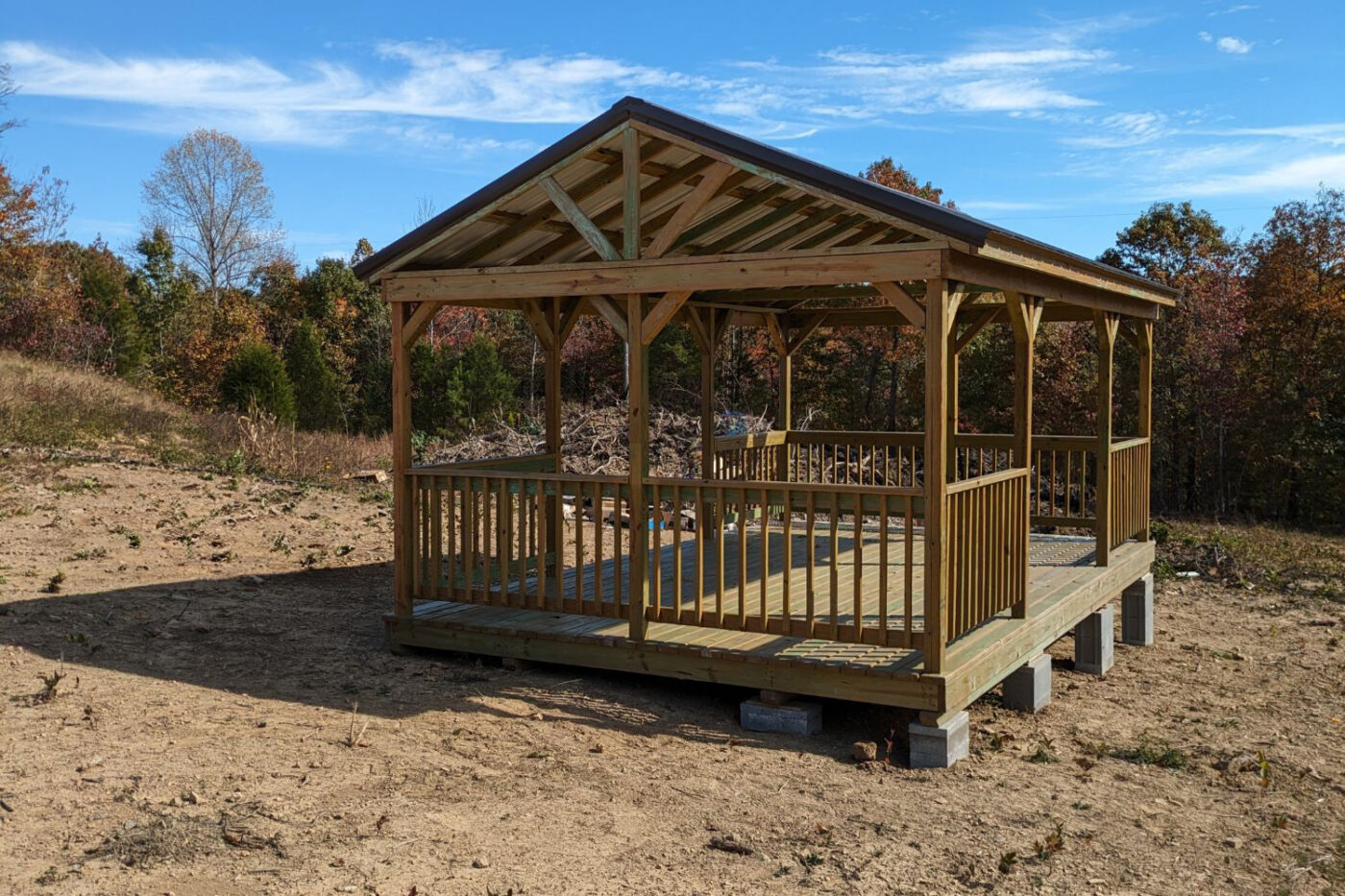 Wooden pavilion in field on a sunny day