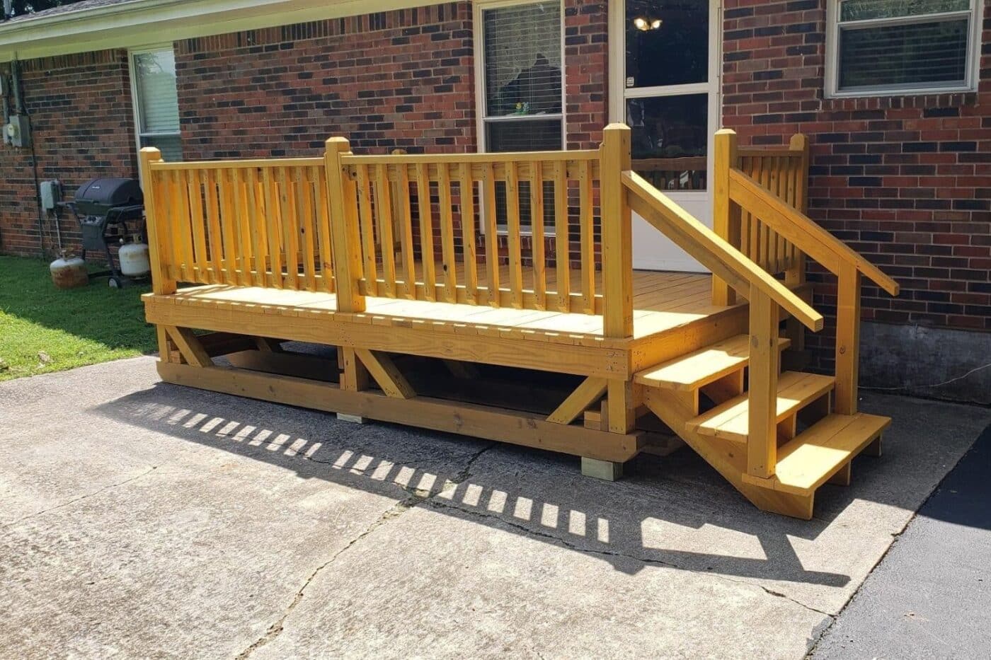 Tennessee Prebuilt DEcks include this house deck with natural stain and steps