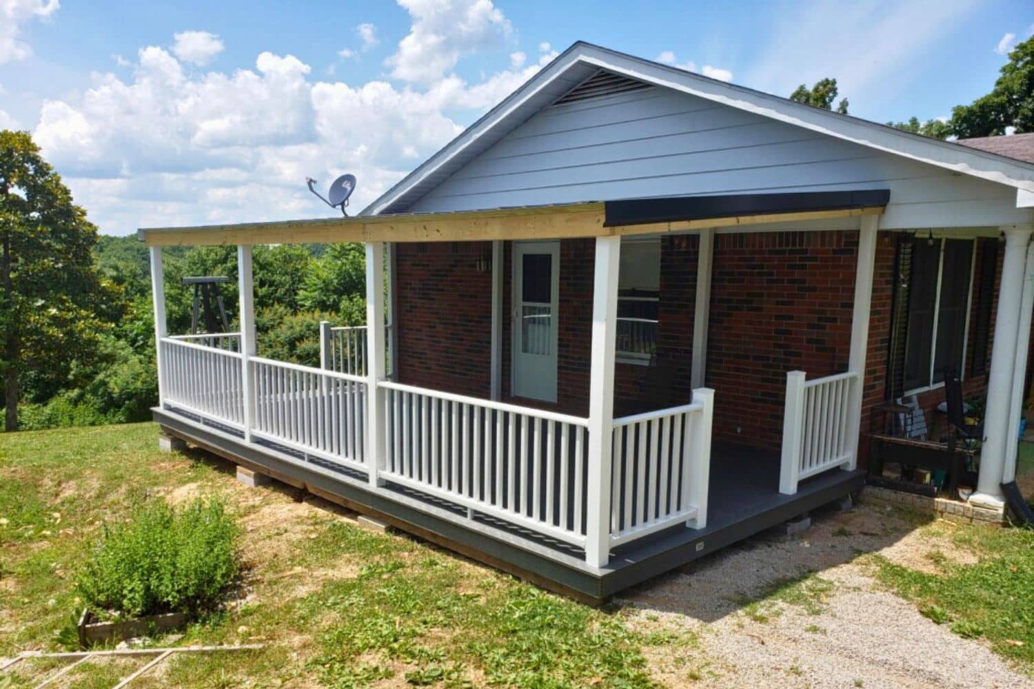 House Porch for sale in Tennessee with white vinyl porch and roof on side of brick house