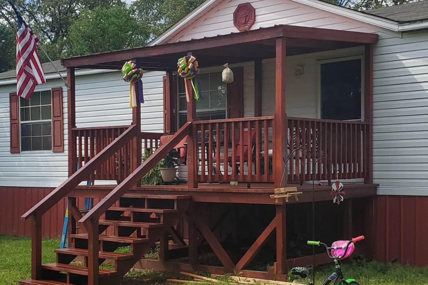 Dark stained mobile home deck outside home in Kentucky