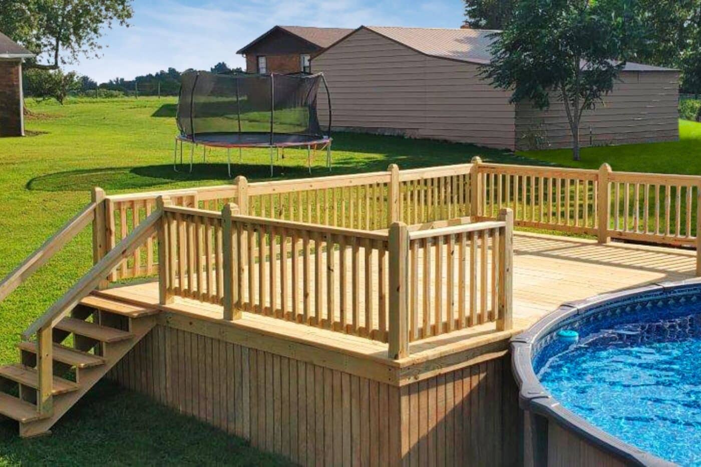 Wooden pool deck besides pool in Kentucky backyard