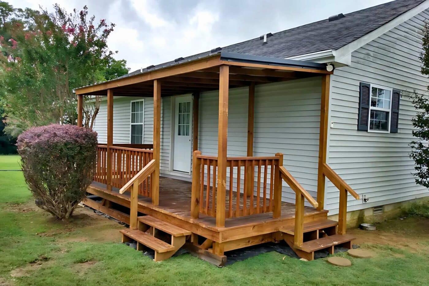 Portable porch in cave city KY with two sets of stairs, railing, and roof overhang