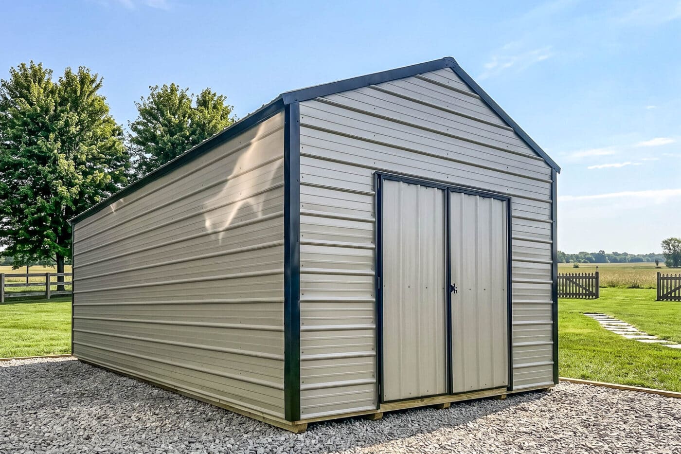 Beige horizontal metal shed with black trim and double doors in a rural yard.